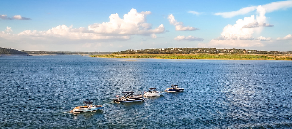 Wake boat, surf boat, and pontoon on Lake Travis in Texas